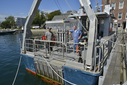 R/V Tioga captain Ken Houtler and crew Ian Hanley on the vessel at the WHOI dock.