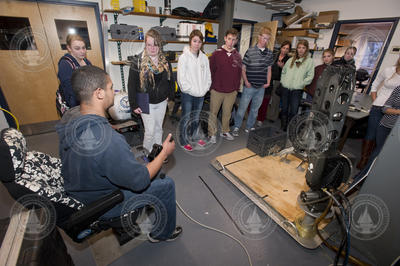 Mario Fernandez (left) showing the FHS students how to operate a manipulator arm