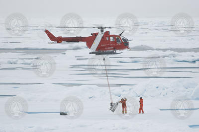 Helicopter pilot Christopher Swannell transfers mooring gear to the field site.