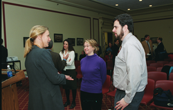 Ruth Curry (left) speaking with attendees at the briefing