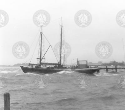 Sailboat docked in Woods Hole during the hurricane of 1938.