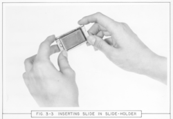 Inserting smoke-glass slide into slide-holder for use in bathythermograph.