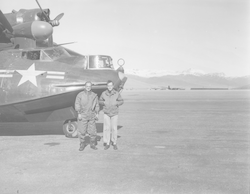 F. S. Matthews and Chuck Spooner next to PBY aircraft