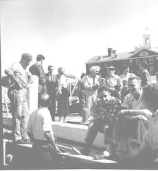 Ralph Vaccaro, Maurice Ewing, J. Hahn and others siting on the dock