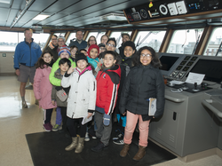 Rick Chandler (left) with students and chaperones on the bridge of Armstrong.