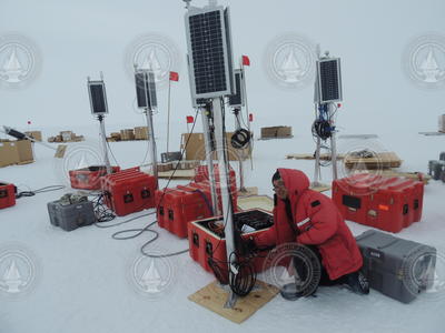 Graduate student Chen Cai sets up a seismic station on the Ross Ice Shelf.