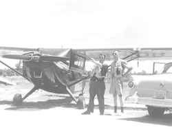 Robert Weeks and Allard T. Spencer next to Stinson aircraft