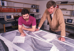 Steve Holbrook and Mike Purdy reviewing a data chart.