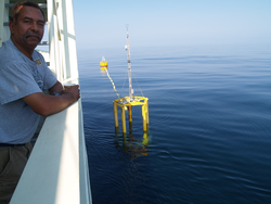 Diego Mello on deck on Oceanus.  Spar buoy in the water.