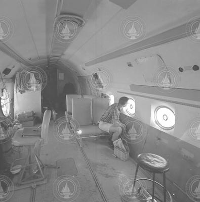 Inside view of C54Q aircraft, man looking out window
