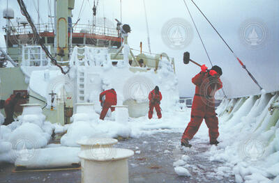 Captain and crew chopping ice off the deck of R/V Knorr in the Labrador Sea.