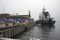 Science Stroll guests on WHOI's dock with R/V Atlantis.