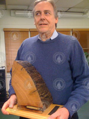 Jim Luyten with plaque made of wood from original R/V Atlantis mast.