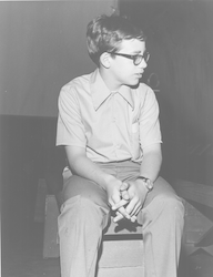 Young Bill Lange sitting in the Hangar Exhibit Center.