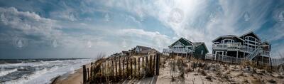 Panorama of Duck, NC coastline, with erosion, dunes, and seaside homes.