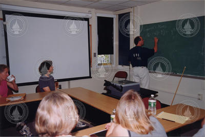 Mike Neubert illustrating his point at the chalkboard.
