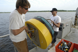 Malcolm Scully and Rocky Geyer move a mooring to a safe location.