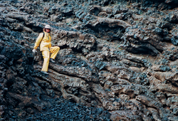 WHOI geologist Debbie Smith climbing down volcanic rock in Iceland.