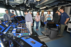 Captain Mike Hoshlyk showing NSF associates the bridge on R/V Sikuliaq.