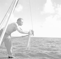 Martin Pollak with instrument over side of ship.