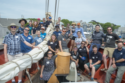Students with Captain Jason Quilter (right) and crew on the bow of SSV Cramer.