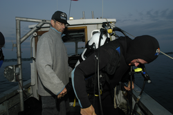 Rocky Geyer with Jay Sisson as he prepares to dive.