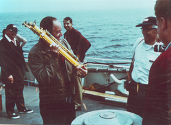 Vice President Humphrey holding instrument.