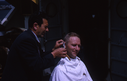 Gordon Volkmann gets a haircut from Capt Hiller