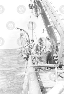 Group working on deck with corer