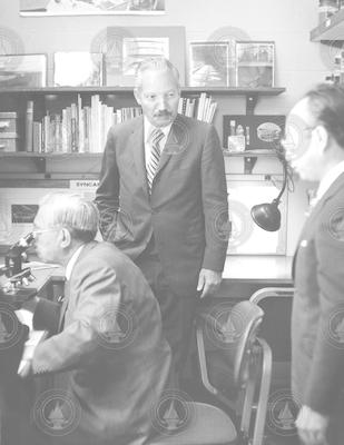 Visiting Emperor Hirohito looking into microscope.