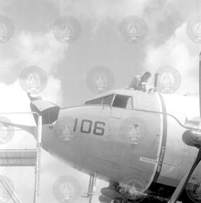 Nose of R4D aircraft, man working on top