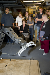 Mario Fernandez (left) showing the FHS students how to operate a manipulator arm