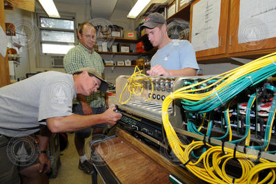 Jay Sisson, Hugh Popenoe, and Jared Schwartz assembling node components.