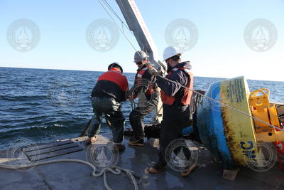 Jeff Pietro, Steve Murphy and Ian Hanley haul in the DMON buoy cable.