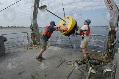 Postdoc Dave Ralston and Jay Sisson recover a mooring bouy.