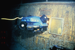 ROV Jason Jr. surveys through hull window into stateroom U. at RMS Titanic wreck site.