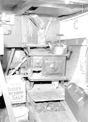 Below deck of Reliance showing stove and kettle.