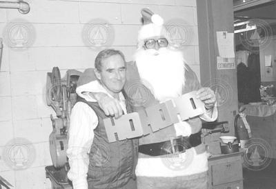 Bobby Weeks and Eric Spencer as Santa for the holiday shop party.