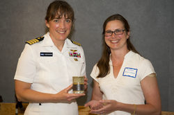 Becky Gast presenting appreciation gift to Captain Stefanyshyn-Piper.