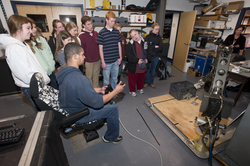 Mario Fernandez shows students how to use a manipulator arm.