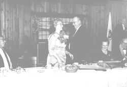 Buck Ketchum pinning corsage on Martha Redfield.
