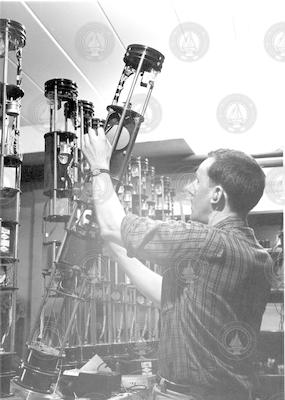 Charles Wilkins working with a row of instruments