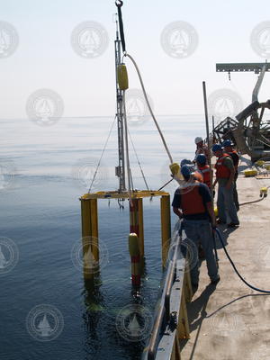 Scientists and crew recovering the spar buoy.
