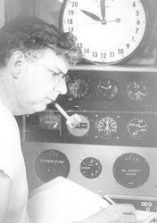 Andrew Bunker writing in front of equipment