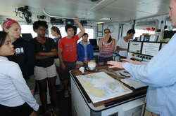 Fellows listening to Captain Ken Houtler during navigation tutorial.