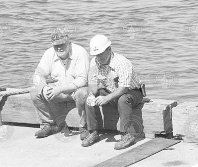 Carl Young (l) and Bobby Weeks sitting on dock