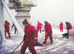 Crew and scientists clearing ice off the fantail deck on R/V Knorr.