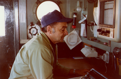 Captain Harry Seibert studies weather report