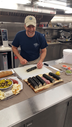 R/V Neil Armstrong chief steward Harry Burnett creating sushi rolls.