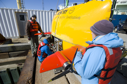 Sean Kelley, Justin Fujii and Hannah Baker prepare to launch Sentry at the dock.